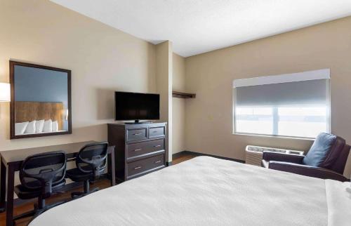 a hotel room with a bed and a flat screen tv at Extended Stay America Premier Suites - Nashville - Vanderbilt in Nashville
