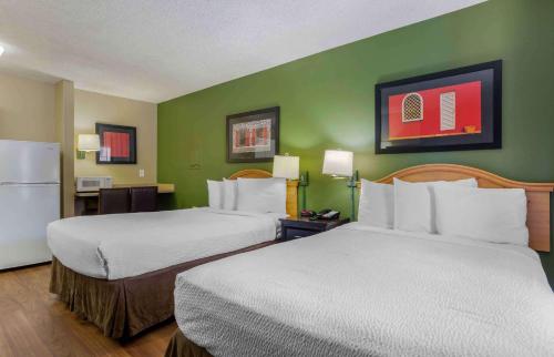 a hotel room with two beds and a refrigerator at Extended Stay America Suites - Phoenix - Scottsdale - Old Town in Scottsdale