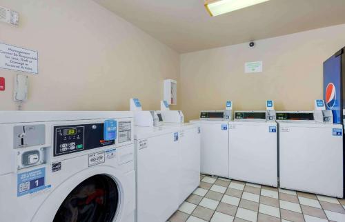 a laundry room with white washers and dryers at Extended Stay America Suites - Phoenix - Scottsdale - Old Town in Scottsdale
