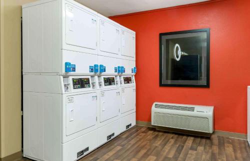 a room with white washers and a red wall at Extended Stay America Suites - Detroit - Canton in Canton