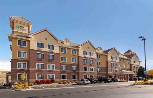 a large building with cars parked in a parking lot at Extended Stay America Suites - Denver - Park Meadows in Lone Tree