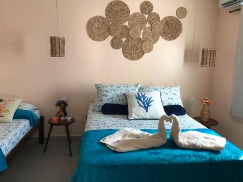 a bedroom with a bed with two animals on it at Casa Beach - Villa Maia Beach São Miguel dos Milagres in São Miguel dos Milagres