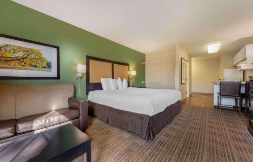 a large hotel room with a bed and a couch at Extended Stay America Suites - Minneapolis - Eden Prairie - Technology Drive in Eden Prairie