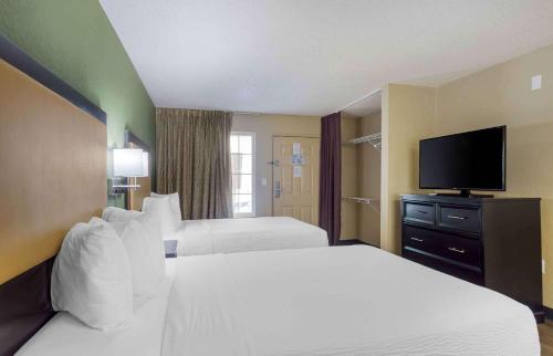 a hotel room with two beds and a flat screen tv at Extended Stay America Suites - Nashville - Franklin - Cool Springs in Franklin