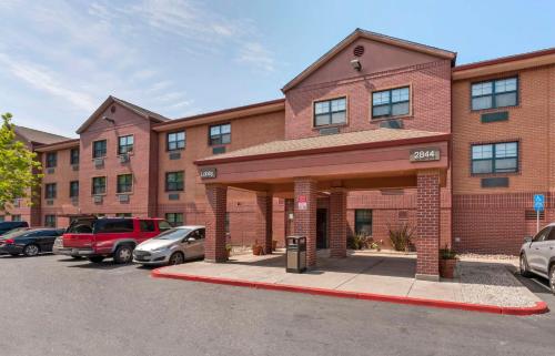 a brick building with cars parked in a parking lot at Extended Stay America Suites - Stockton - March Lane in Stockton