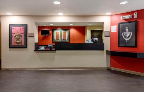 a waiting room with red walls and a mirror at Extended Stay America Suites - Orange County - Katella Ave in Orange