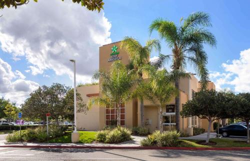 a hotel with a palm tree in front of a building at Extended Stay America Suites - Orange County - Irvine Spectrum in Irvine