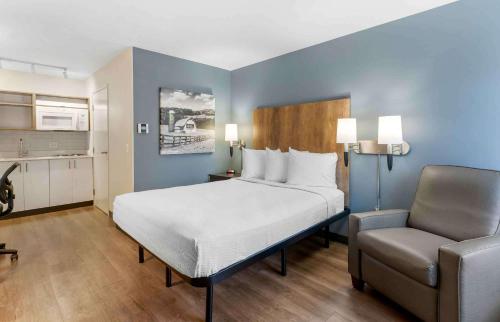 a bedroom with a large bed and a chair at Extended Stay America Suites - San Jose - Milpitas - McCarthy Ranch in Milpitas