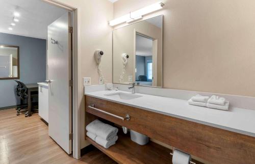 a bathroom with a sink and a large mirror at Extended Stay America Suites - San Jose - Milpitas - McCarthy Ranch in Milpitas