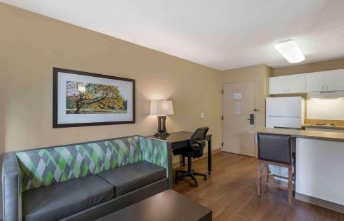 a living room with a couch and a desk in a room at Studio 6 Extended Stay Memphis Airport TN in Memphis