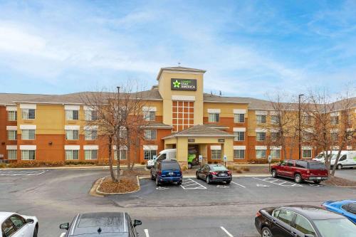 a hotel with cars parked in a parking lot at Extended Stay America Select Suites - St Louis - Airport - Central in Bridgeton