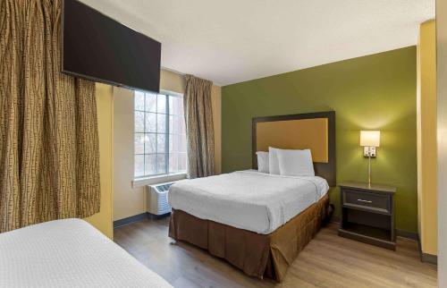 a hotel room with two beds and a window at Extended Stay America Suites - St Louis - Airport - Central in Bridgeton