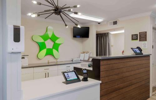 a hospital room with a cell phone on a counter at Extended Stay America Suites - Dallas - Coit Road in Dallas
