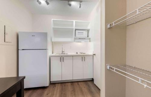 a kitchen with a white refrigerator in a room at Extended Stay America Suites - Dallas - Coit Road in Dallas