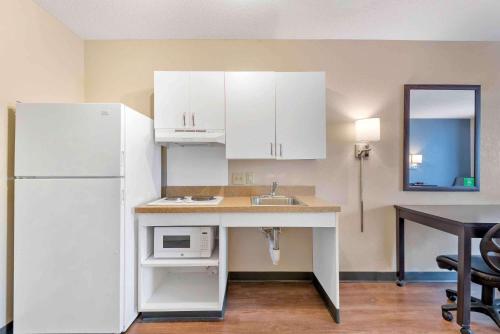 a kitchen with a sink and a white refrigerator at Extended Stay America Suites - Dallas - Coit Road in Dallas