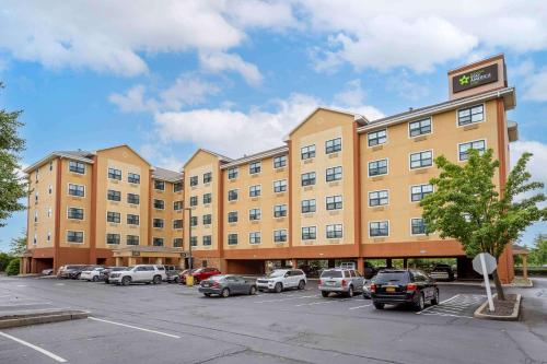 a large building with cars parked in a parking lot at Extended Stay America Suites - Meadowlands - Rutherford in Rutherford