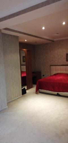 a bedroom with a red bed in a room at Abu Arena Hall in Baku