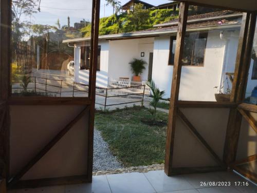 an open door to a house with a yard at El Paso Gh #3 in Guarne