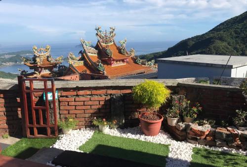 a temple on top of a building with a garden at A-HOME in Jiufen