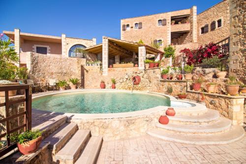 a house with a swimming pool in a yard at Samonas Traditional Villas in Samonás