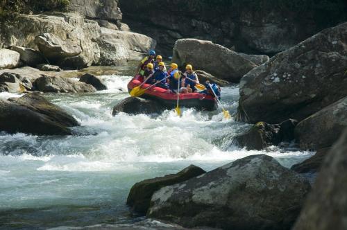 a group of people in a raft in a river at Pousada Encontro dos Rios in Lumiar