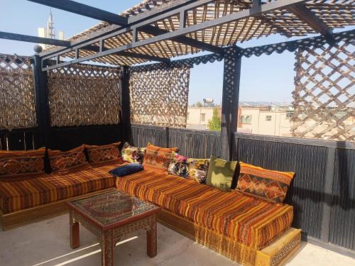 a patio with two couches and a table on a balcony at Dar Suncial in Marrakesh