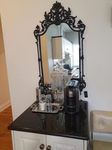 a counter with a mirror and a coffee maker on it at Outstanding property Close to Melb Airport in Melbourne