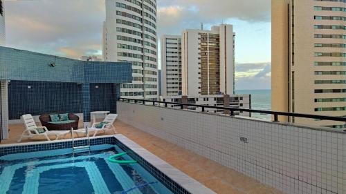 a swimming pool on the roof of a building at Charming 1-BR Apartment in Boa Viagem - with Ocean View in Recife