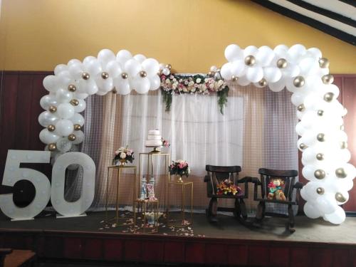 a set up for a anniversary party with balloons and a sign at Hotel MAXIRUMA - Villa TAMAUKA in Iza