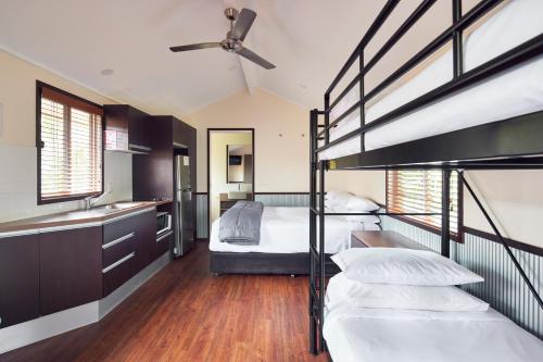 a bedroom with two bunk beds and a sink at NRMA South West Rocks Holiday Park in South West Rocks