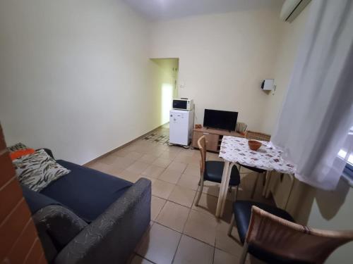 a living room with a couch and a table at Copacabana Posto 6 até 3 pessoas in Rio de Janeiro