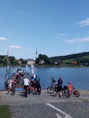 a group of people riding bikes on a dock near a river at Apartman LEO Nr. 8 Lipno nad Vltavou in Lipno nad Vltavou