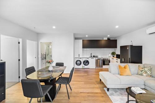 a living room with a couch and a table at Remarkable Mountain Scene - A Modern Escape in Frankton Wharf