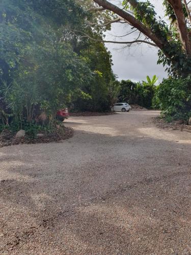 a gravel parking lot with a car parked in it at Eden House Retreat in Yungaburra
