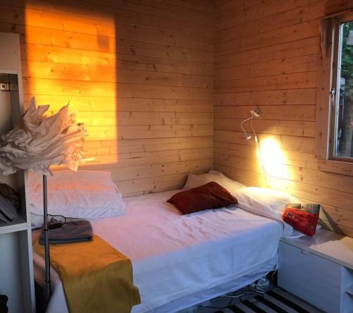 a bedroom with two beds in a wooden wall at Houses by the sea near the city in Lidingö