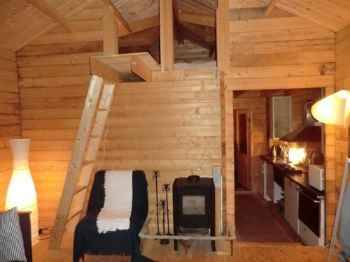 a room with a fireplace in a log cabin at Houses by the sea near the city in Lidingö