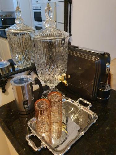 a counter with two glass siphons on a counter top at Grandhome Melbourne Airport & Shops in Melbourne