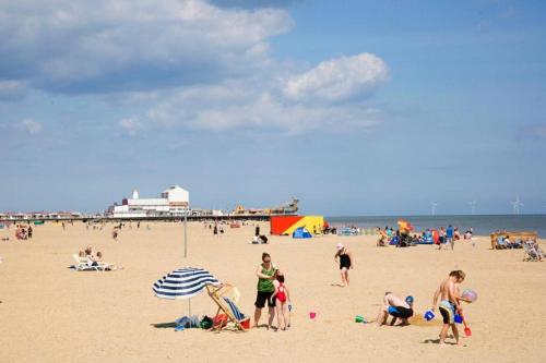 a group of people on the beach at the beach at The Lyndhurst Guest House in Great Yarmouth