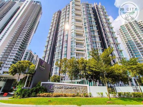 a group of tall buildings in a city at Medini Signature Suites by RR JBcity in Nusajaya