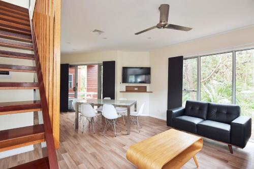 a living room with a black couch and a table at NRMA South West Rocks Holiday Park in South West Rocks