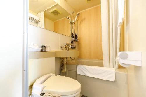 a small bathroom with a toilet and a sink at HOTEL Third Place Hakata in Fukuoka
