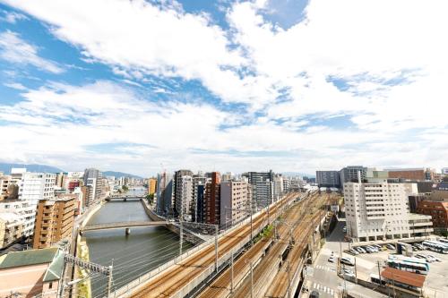 a view of a city with a river and buildings at HOTEL Third Place Hakata in Fukuoka