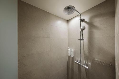 a shower with a shower head in a bathroom at Fairfield by Marriott Fukuoka Ukiha in Ukiha