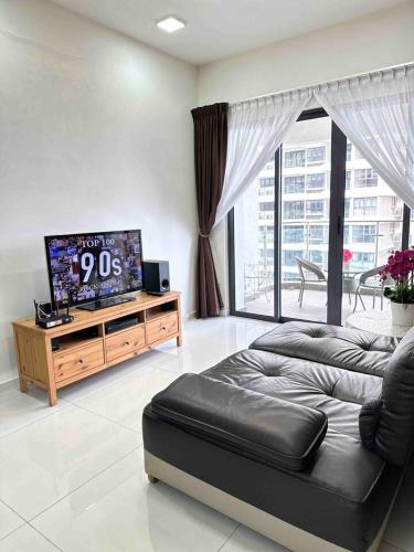a living room with a couch and a flat screen tv at Sun Seaview Country Garden Danga Bay Luxury Condominium in Johor Bahru