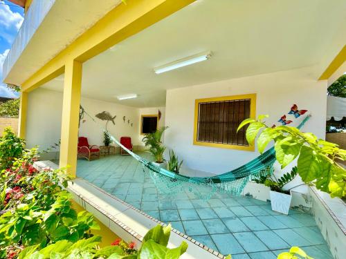 a porch with a hammock in a house at Casa Ilha de Itamaracá in Vila Velha