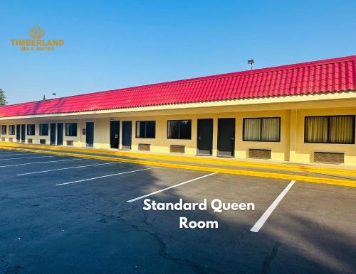 a parking lot in front of a stanford queen room at Timberland Inn & Suites in Castle Rock