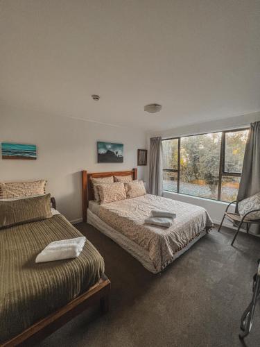 Postel nebo postele na pokoji v ubytování Evergreen Escape Hokitika