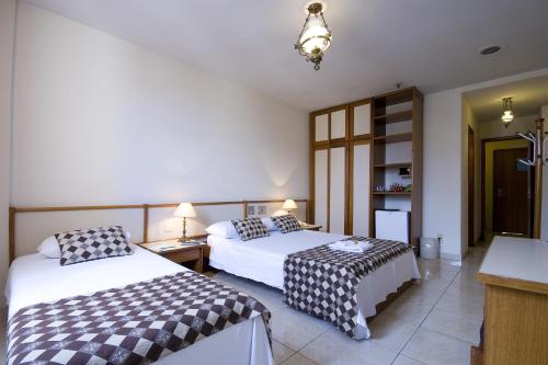 מיטה או מיטות בחדר ב-Hotel Rondônia Palace