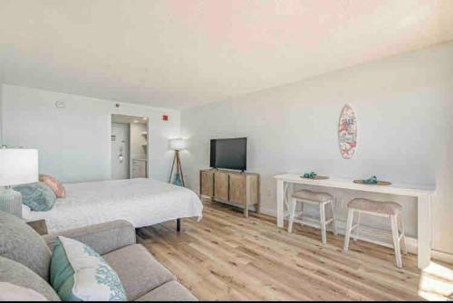 a bedroom with a bed and a desk and a television at Soul Sanctuary-Direct oceanfront-Million dollars view-King bed-Free Parking-Self check-in in Myrtle Beach