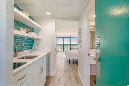 a kitchen with white counters and a green door at Soul Sanctuary-Direct oceanfront-Million dollars view-King bed-Free Parking-Self check-in in Myrtle Beach